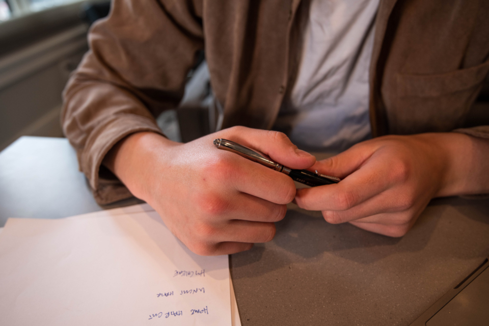 Small business owner reviewing license paperwork at a desk