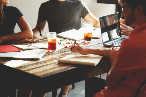Startup team planning a grant application around a table