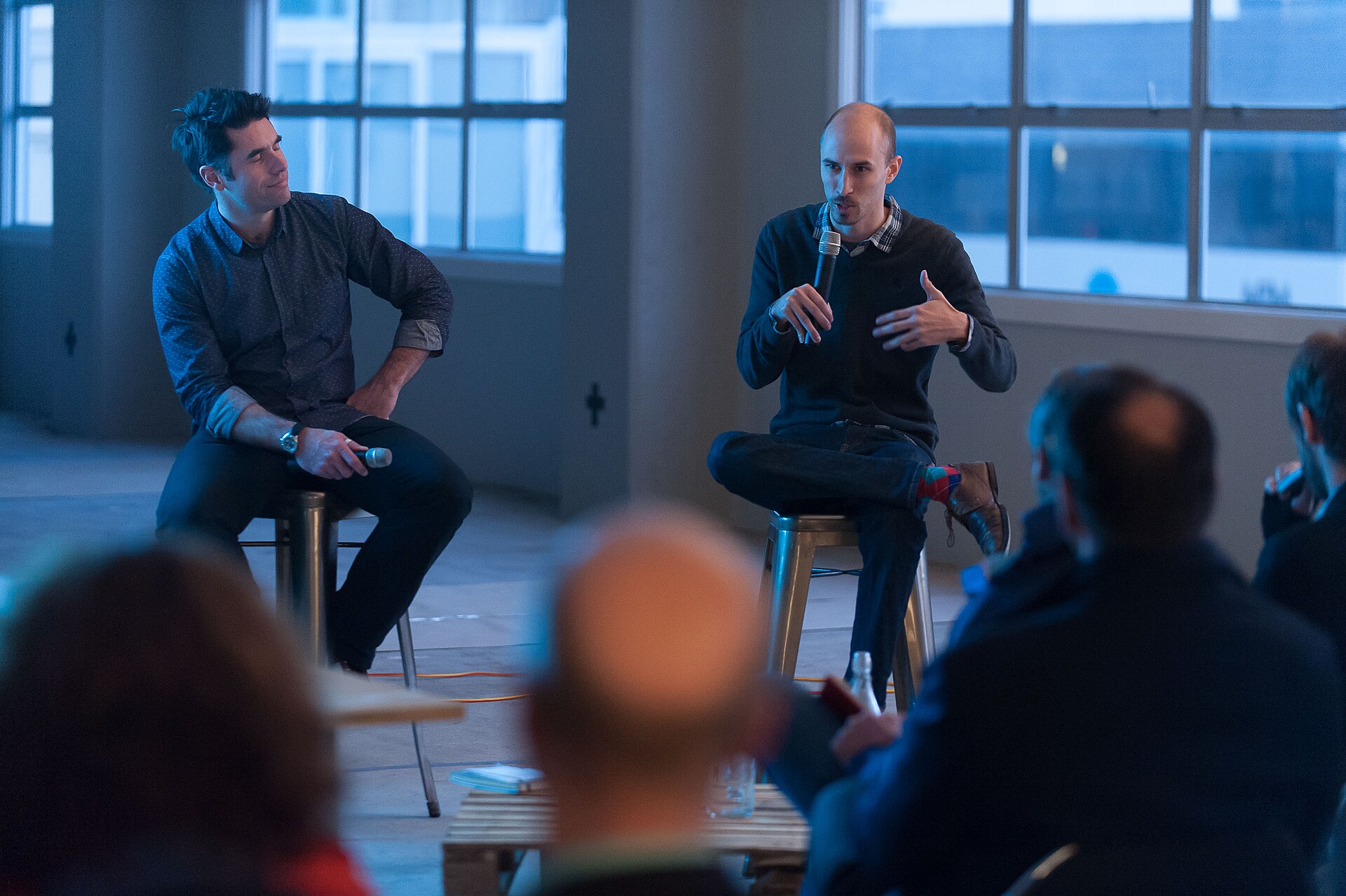 Two founders talking over coffee at a meetup